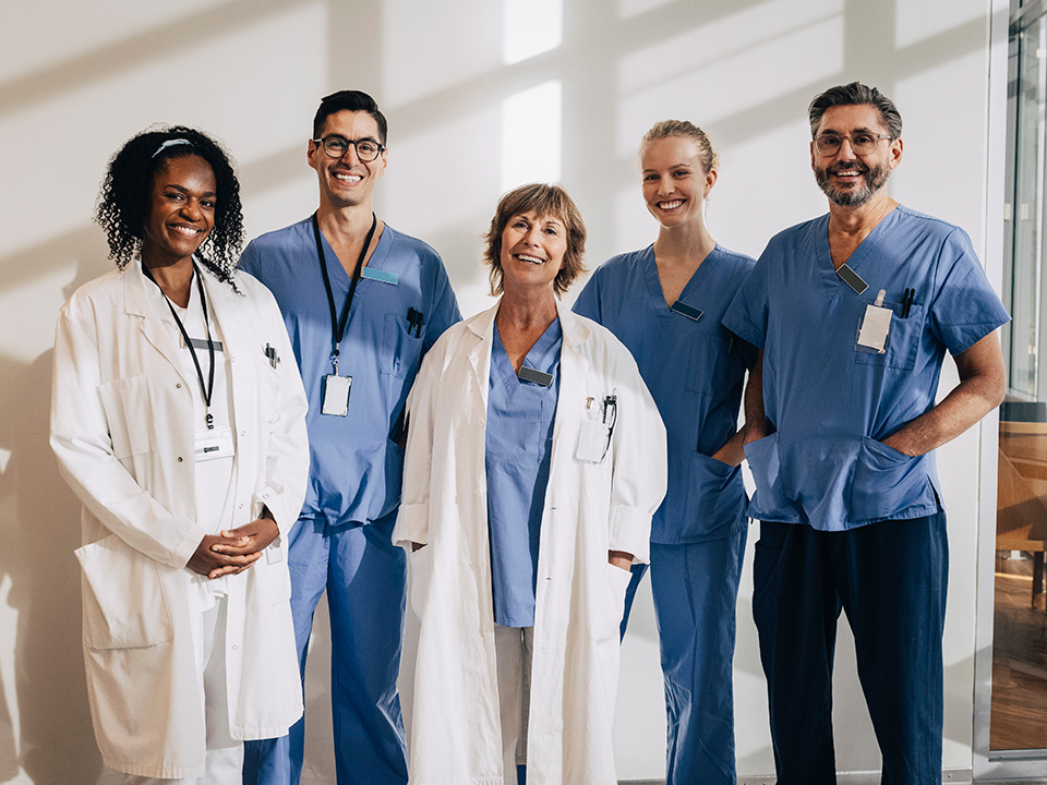 Team of Corewell Health liver transplant medical staff stand side-by-side smiling