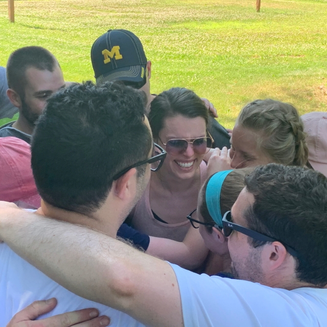 Group huddle of residents during an outdoor training activity event