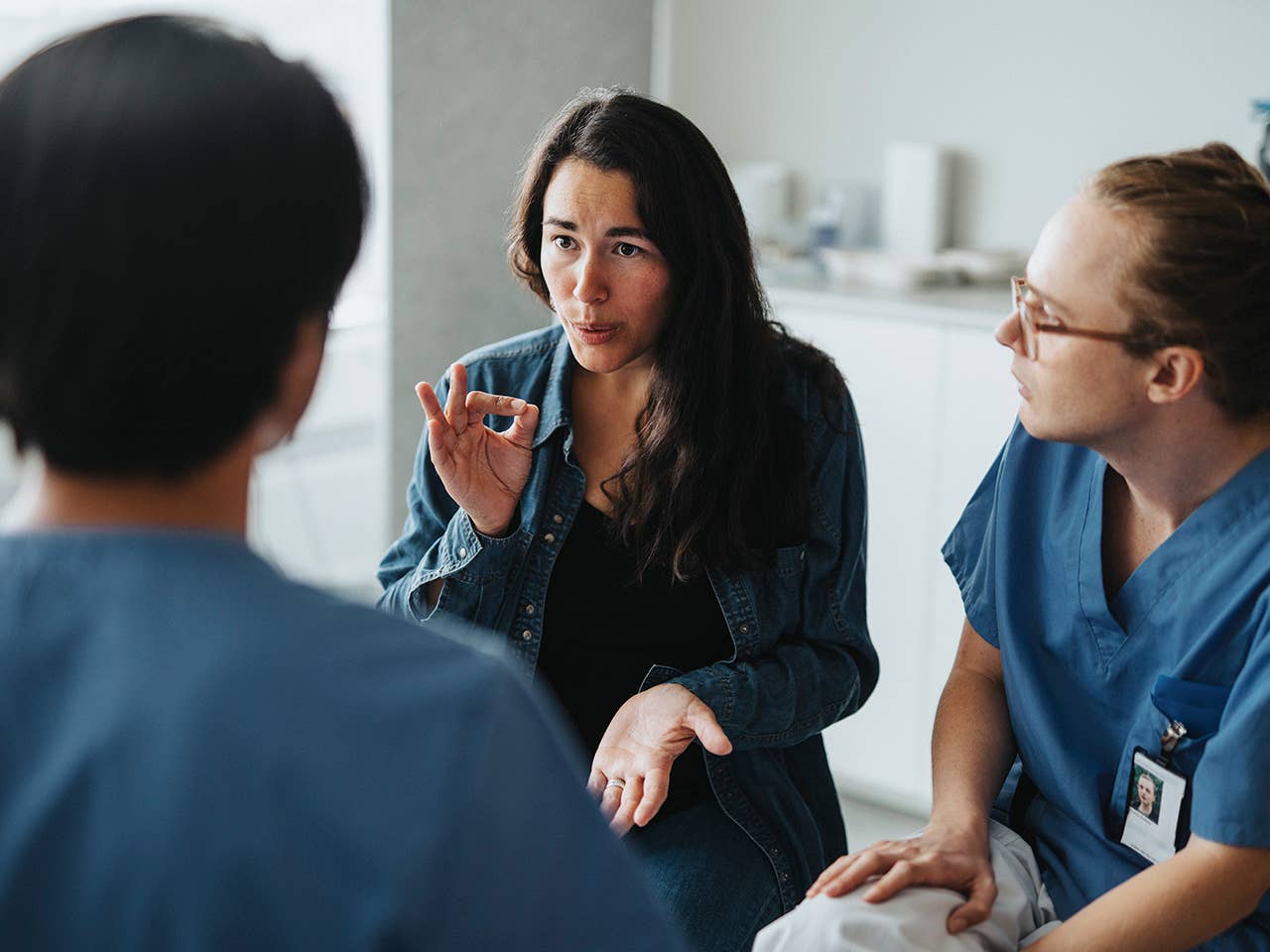 an interpreter is explaining something to a patient
