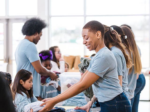 Group of people working together to do a community project by packing bags