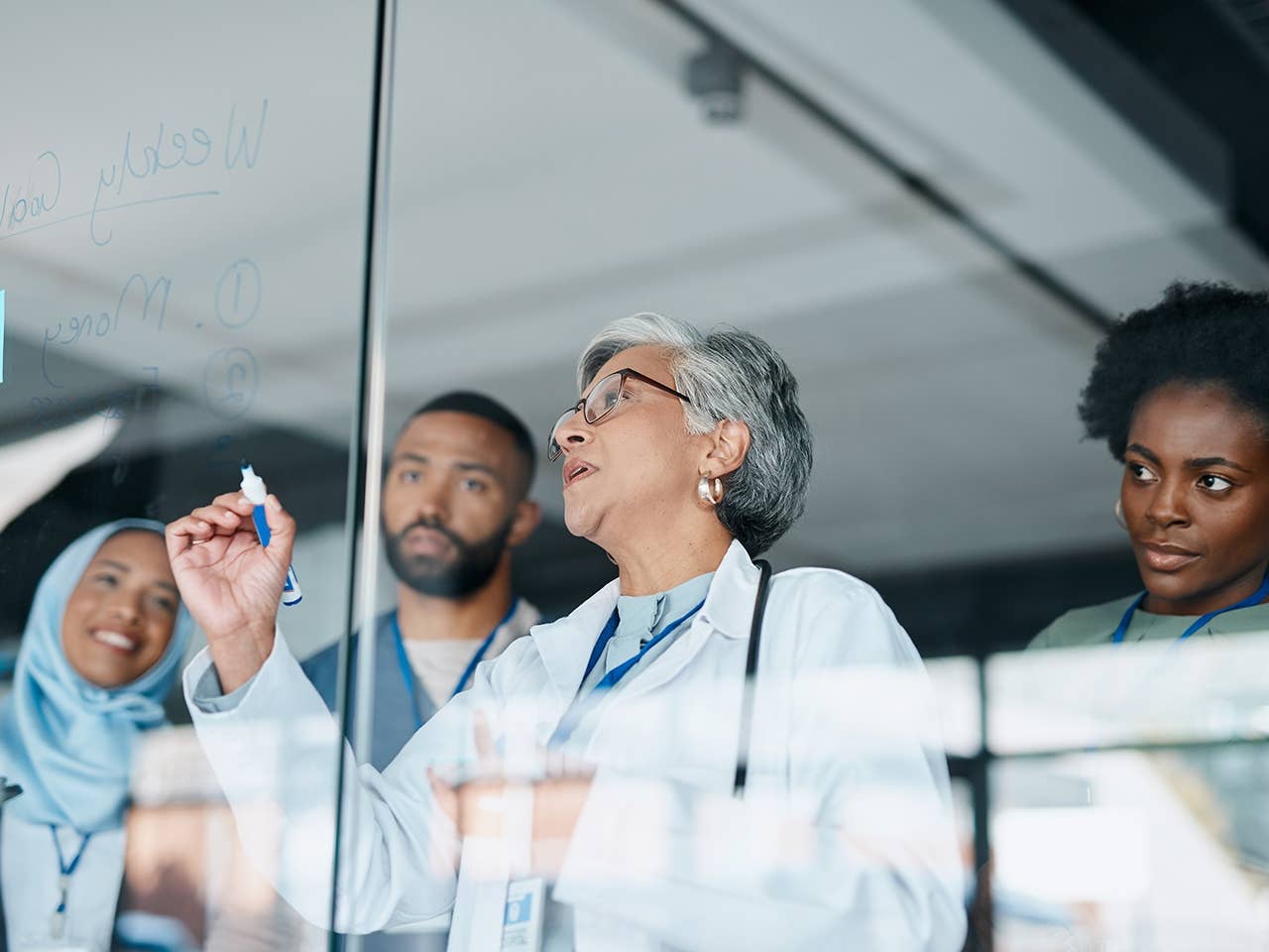 A group of physicians collaborate during a team meeting.