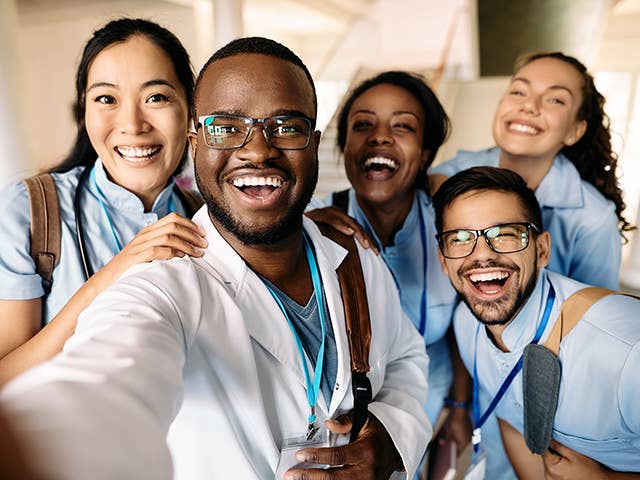 photo of a group of people of different backgrounds posing for a picture