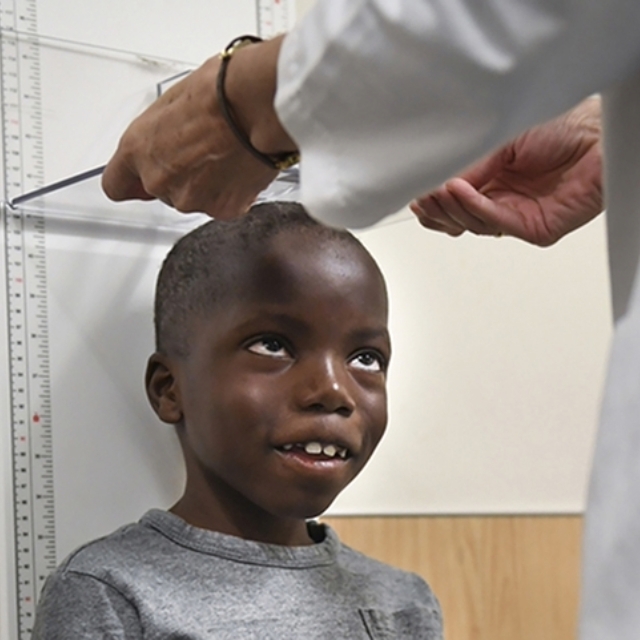 Child getting his height measured.