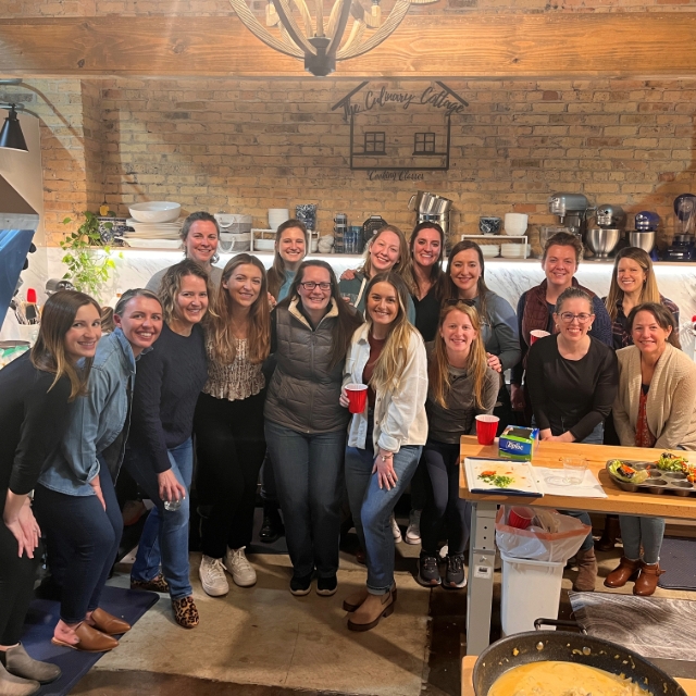 group of female residents posing for a picture at a group cooking class