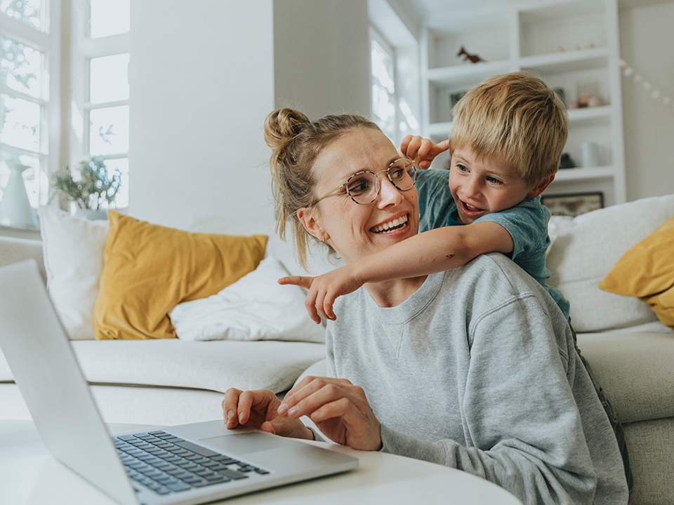 Mother and child with laptop computer