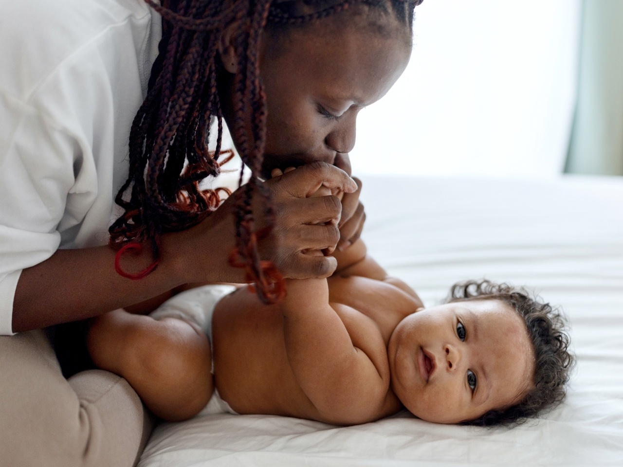 Woman kissing her baby