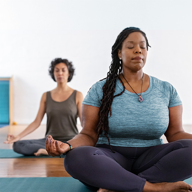 Women practicing yoga during a group class