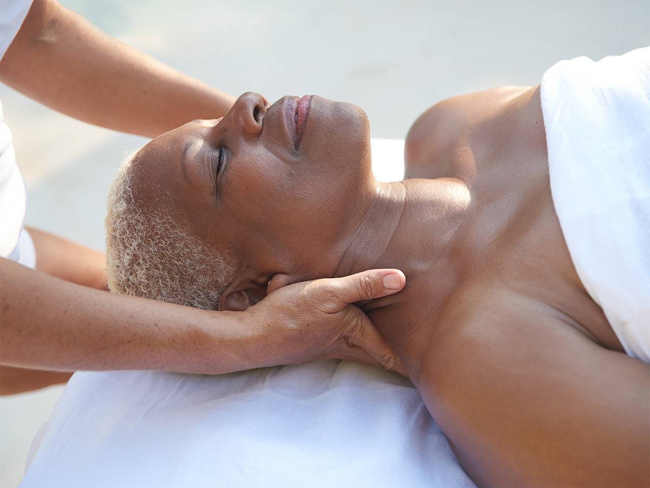 A female oncology patient is getting a massage