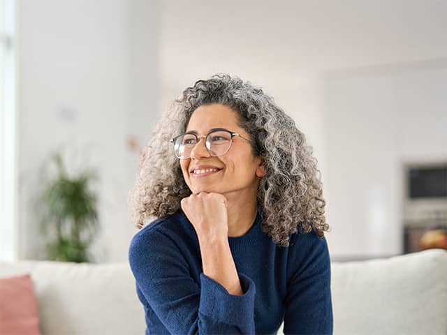 Adult patient seated on a couch with hand resting under chin