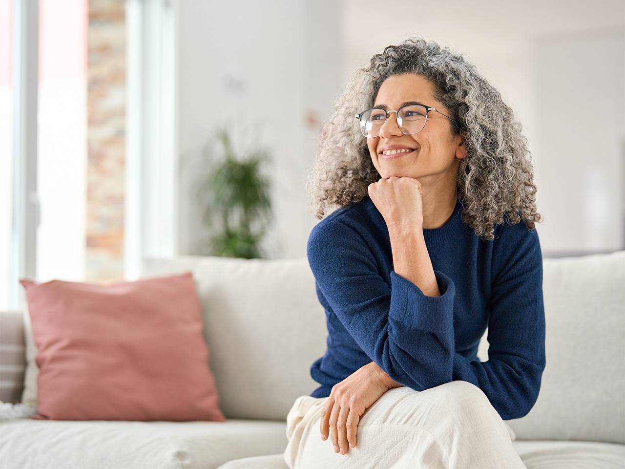 Adult patient seated on a couch with hand resting under chin