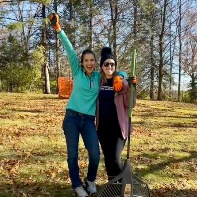 Two residents posing for a picture outside on a fall and sunshiny day