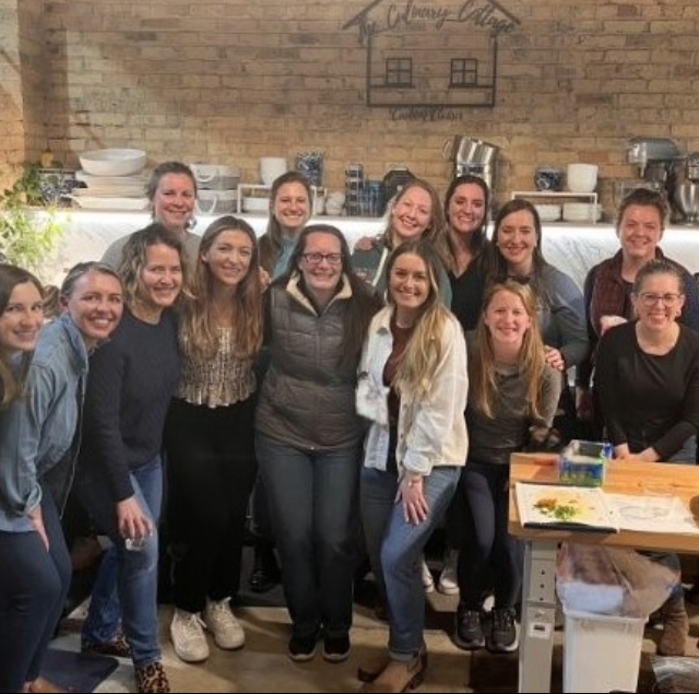 group of female residents posing for a picture at a group cooking class