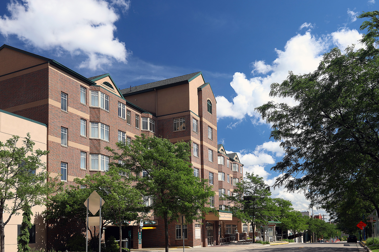 Renucci Hospitality building with a blue sky and clouds in the background