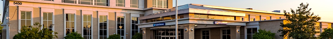 Corewell Health Trenton Hospital, a large facility with a significant sign, offering various medical specialties and trauma care.