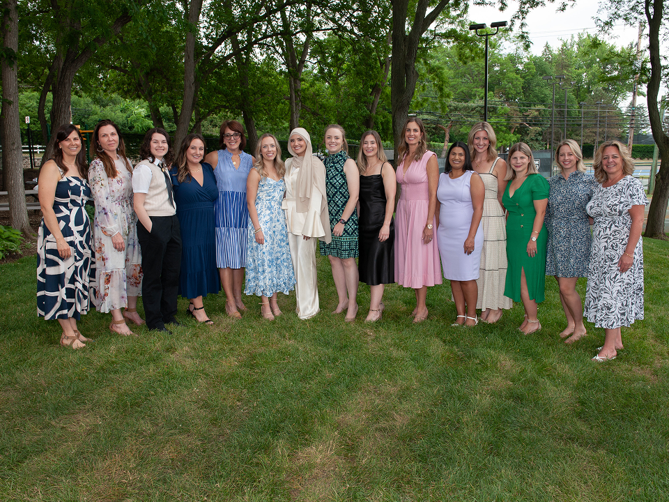 Group photo of faculty and residents from the Farmington Hills team posing outside