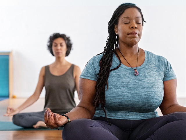 Women practicing yoga during a group class.