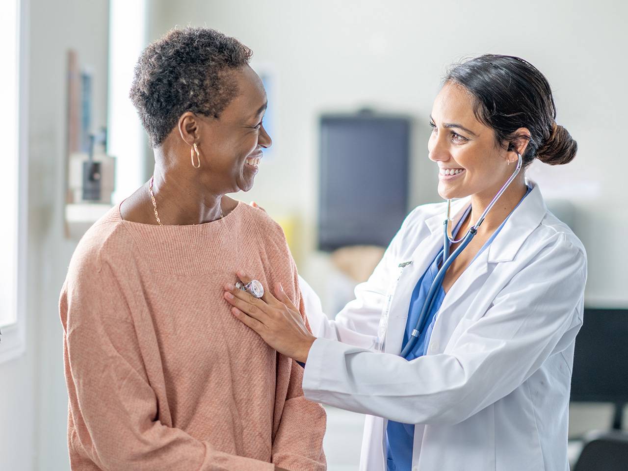 Doctor talking to a patient while they check out there heart