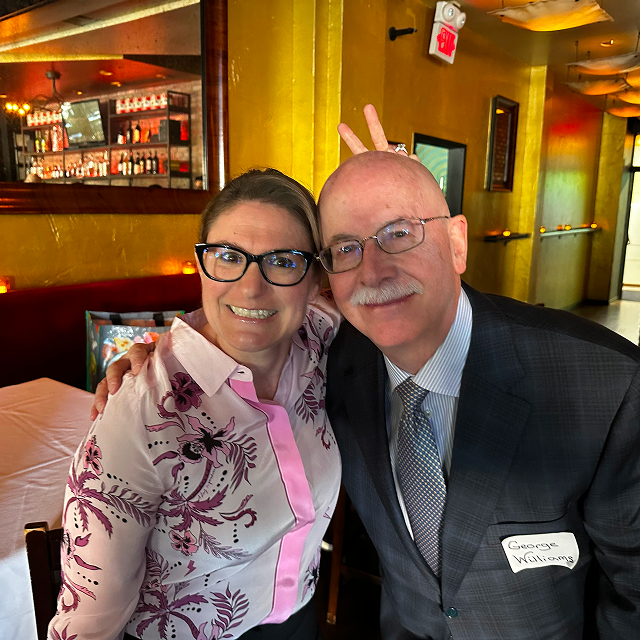 Two attendees posing together for a photo at a residency celebration dinner