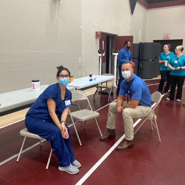 male and female doctors sitting by a table waiting for their next patients