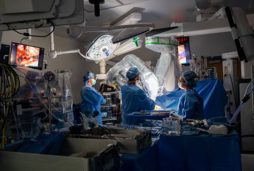 surgery team using robotic arm