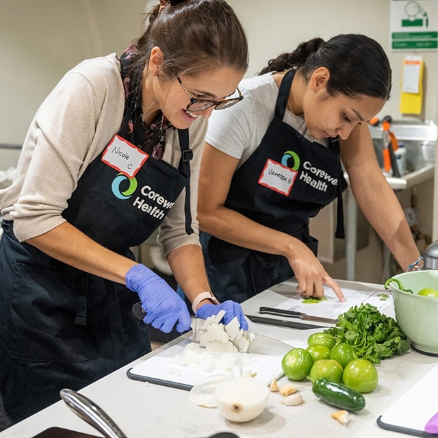 Corewell Health employees preparing food for a meal.