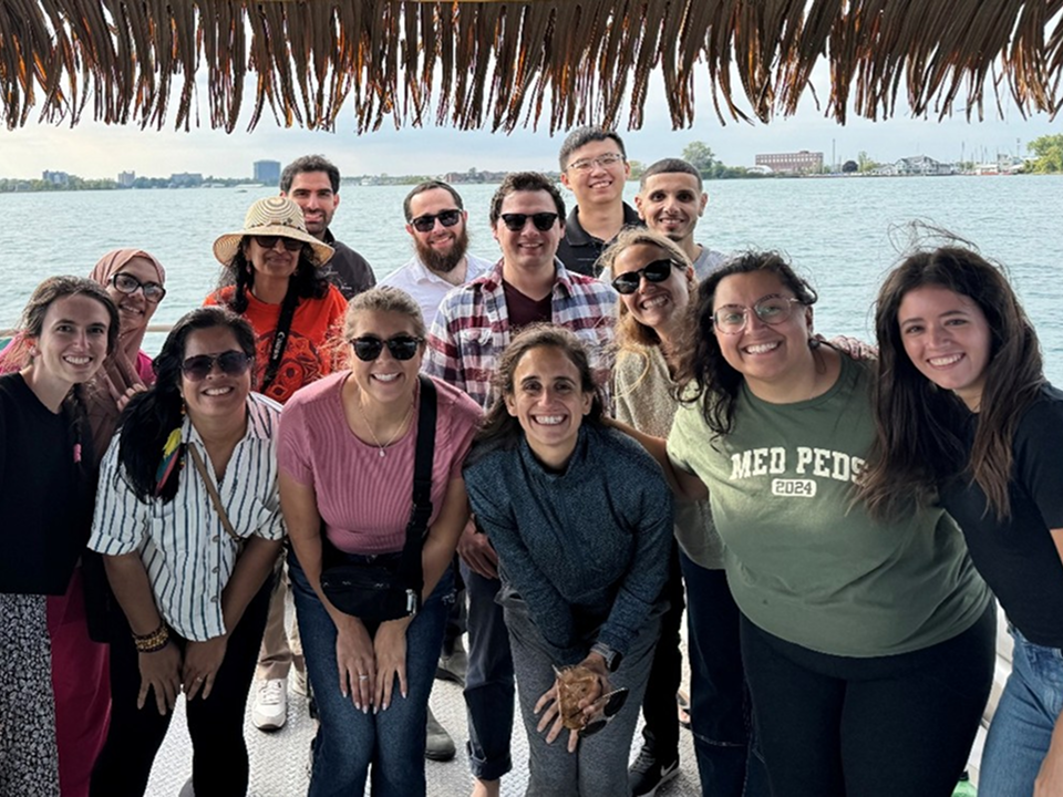 Internal Medicine and Pediatrics residents posing together outdoors during a residency social event.
