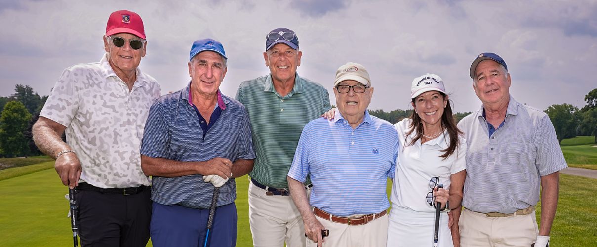 Group of 6 golfers on a tee box