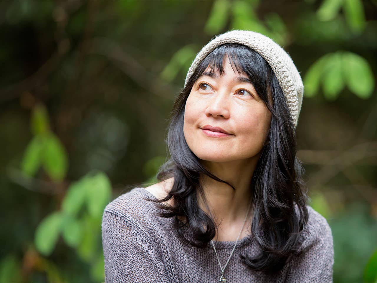 Woman with shoulder length dark brown hair smiles