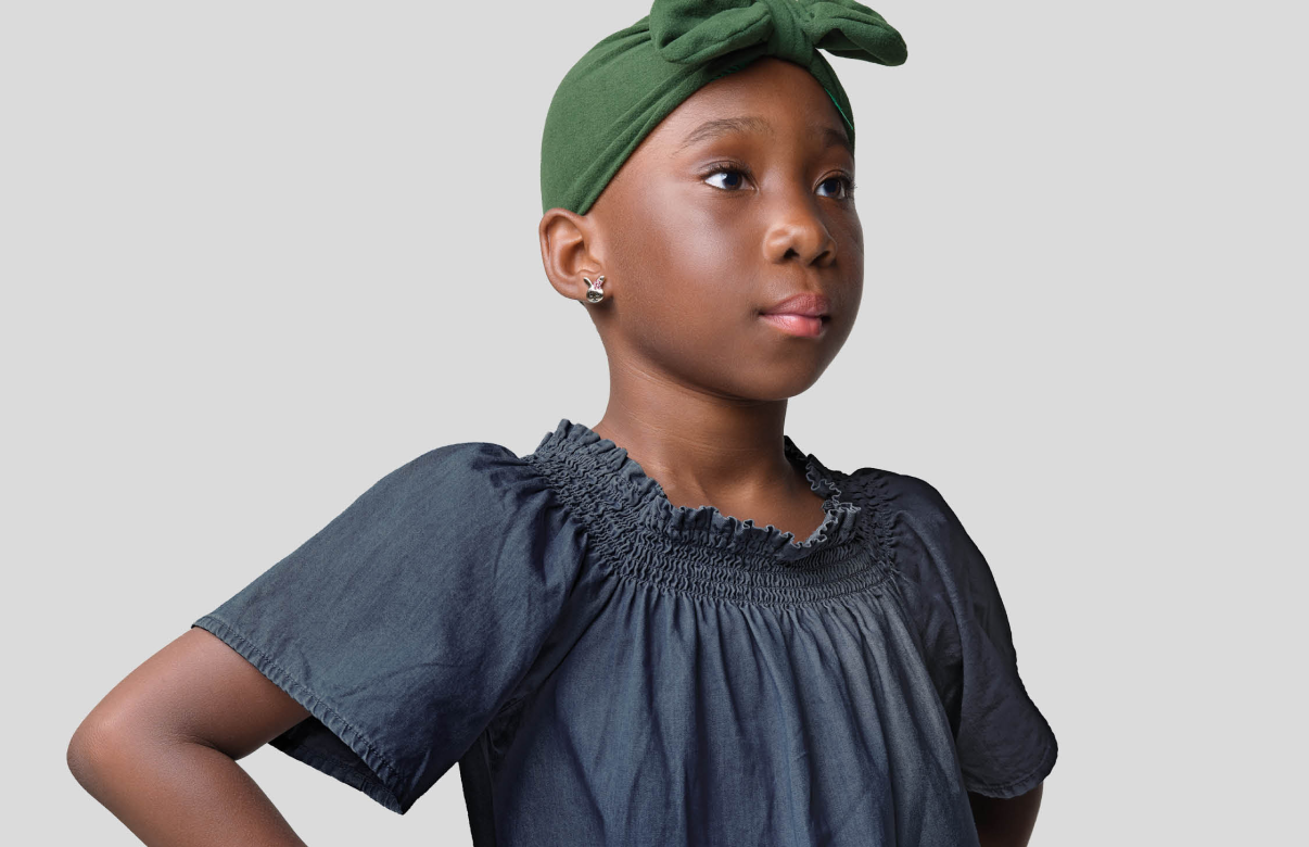 Adolescent black girl wearing a dark blue shirt with dark green headband