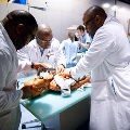 A team of doctors and nurses caring for a newborn, showcasing dedication and teamwork in a medical setting.