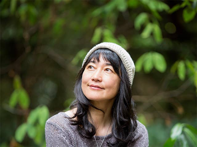 Woman with shoulder length dark brown hair smiles