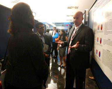 A man in a suit engages in conversation with individuals in a hallway at Dearborn Cardiology.