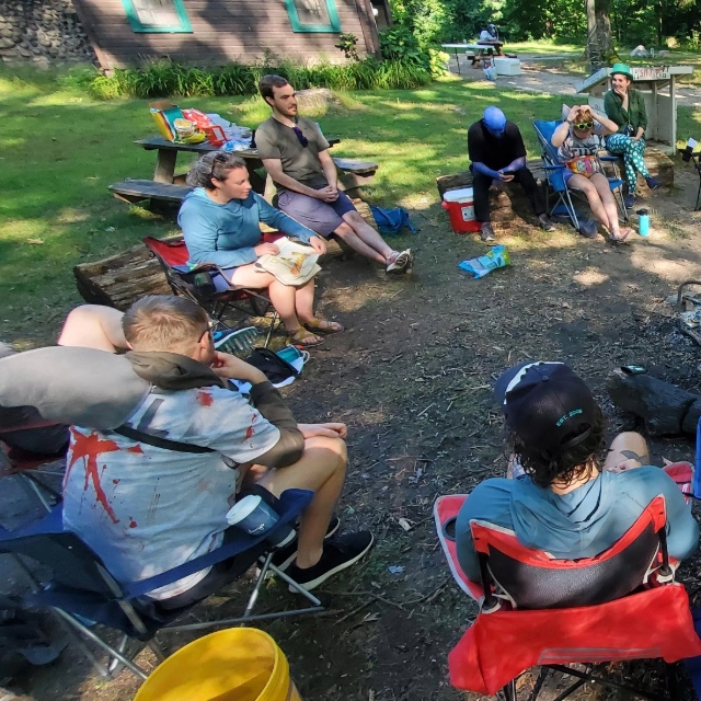 Residents sitting with each other in a circle talking during the wilderness retreat