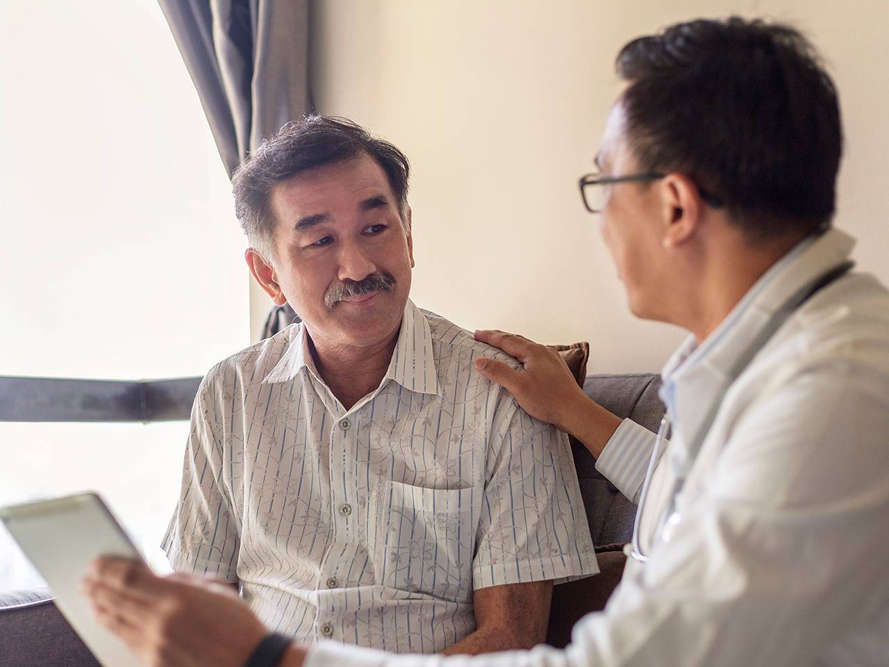 Doctor consulting with a patient, discussing health concerns.