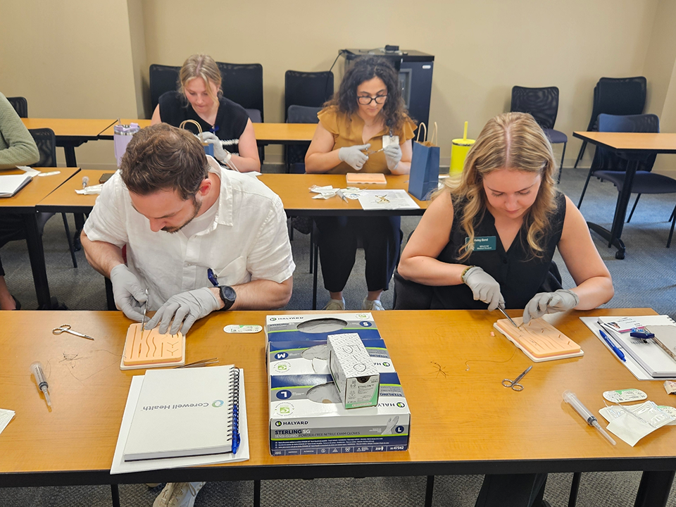 Visiting medical students practicing clinical skills using simulation models in a classroom setting