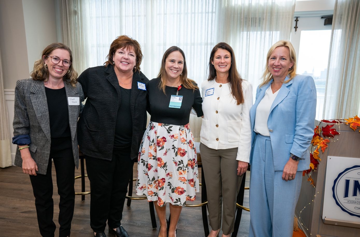 Four panel members posing for a group picture after the event