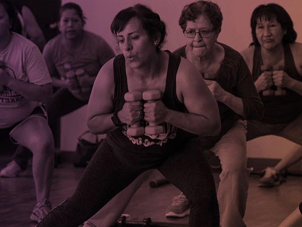Group of women holding weights during a workout class.