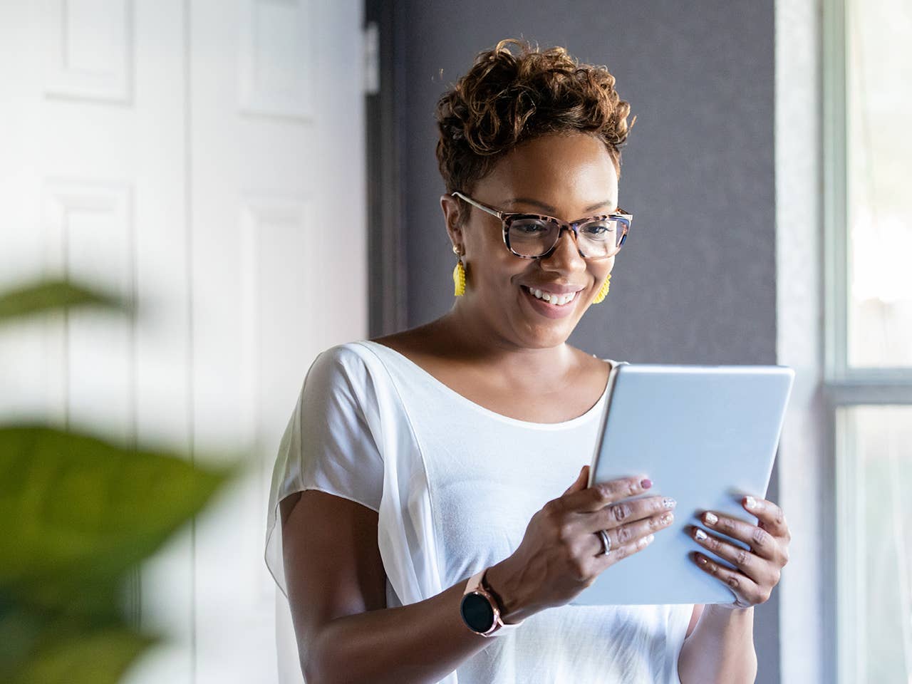 Woman uses mobile device to access Corewell Health MyChart account
