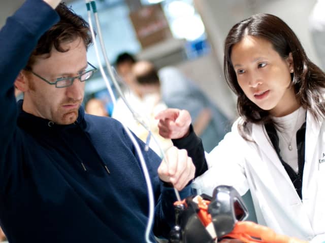Two pediatric doctors working on something together at the hospital