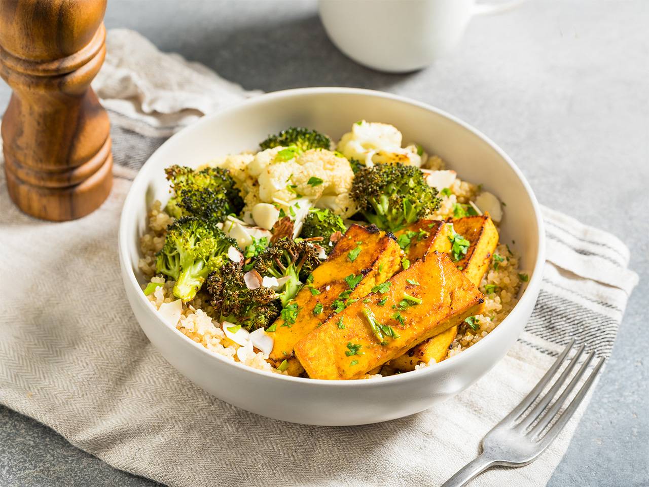 A bowl filled with broccoli, cauliflower, and pieces of chicken, showcasing a colorful and nutritious meal.