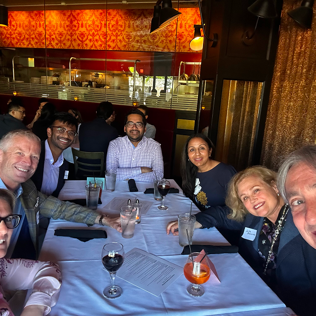 Attendees gathered around a dining table during a residency celebration dinner