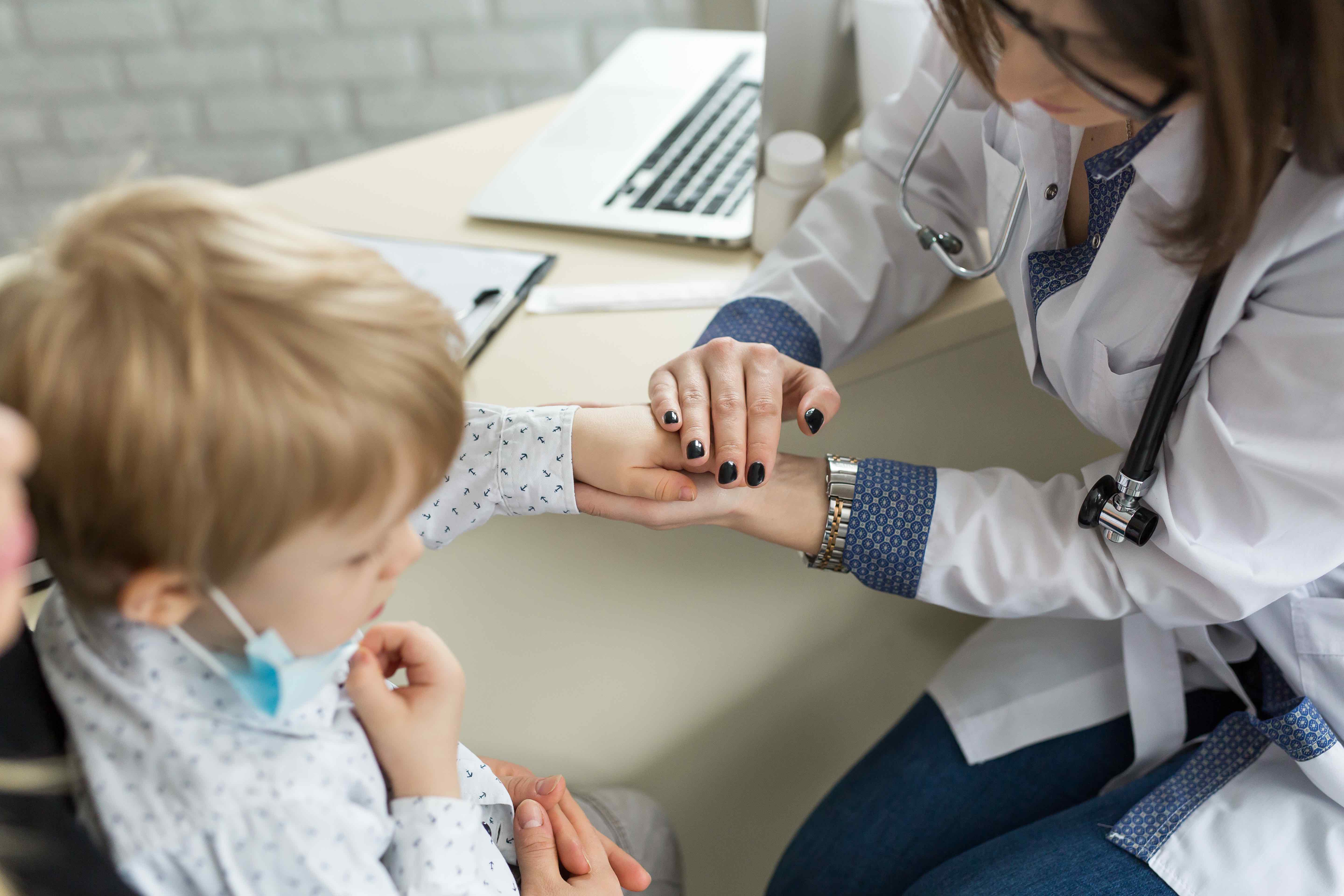 Team member holding hand of a child