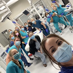 Female nurses gather for a photo in a hospital, representing unity and leadership in the Emergency Medicine department.