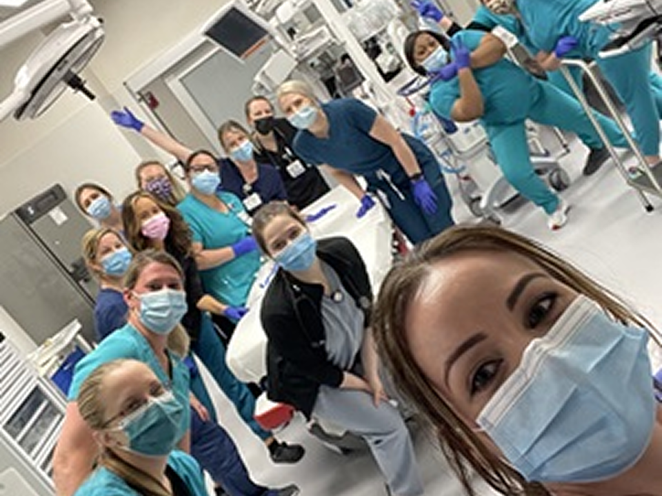 Female nurses gather for a photo in a hospital, representing unity and leadership in the Emergency Medicine department.