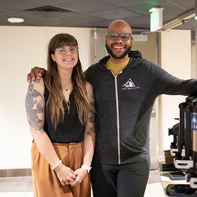 Arick and Sarah Davis standing next to a row of coffee carafes