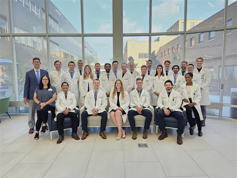 A group of individuals in white lab coats, representing Graduate Medical Education in Orthopaedic Surgery in West Michigan.