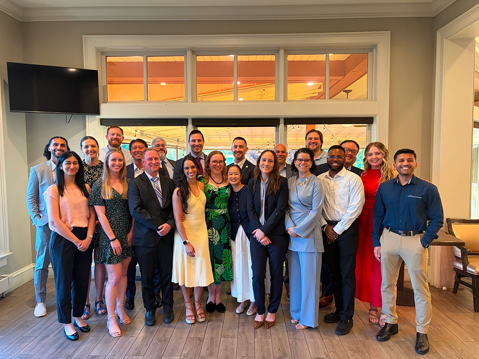 Physical Medicine and Rehabilitation residents, faculty, and staff gathered for a graduation celebration group photo.