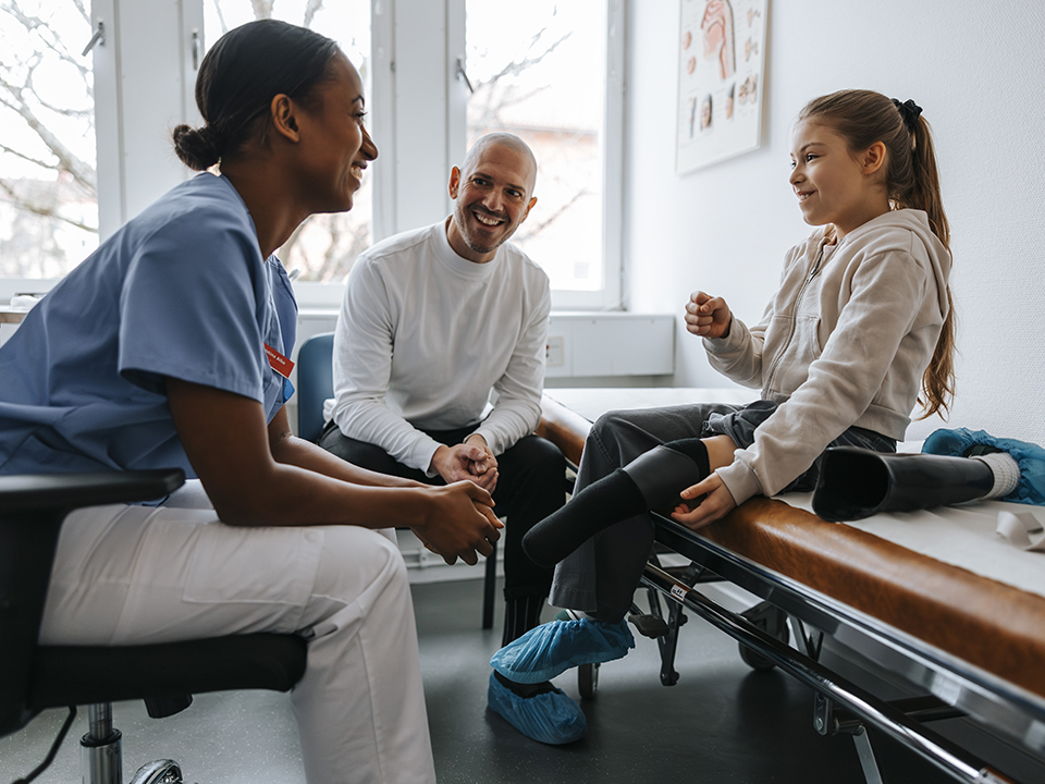 A doctor speaks with a child patient, providing medical advice and support during their visit.