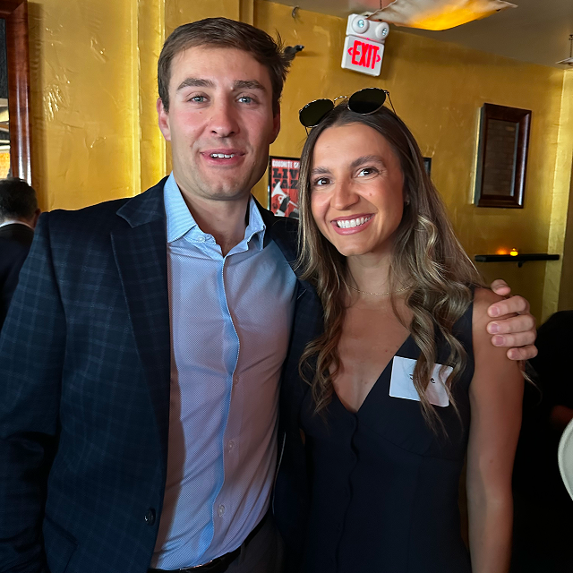 Three attendees posing together for a photo during a residency celebration dinner