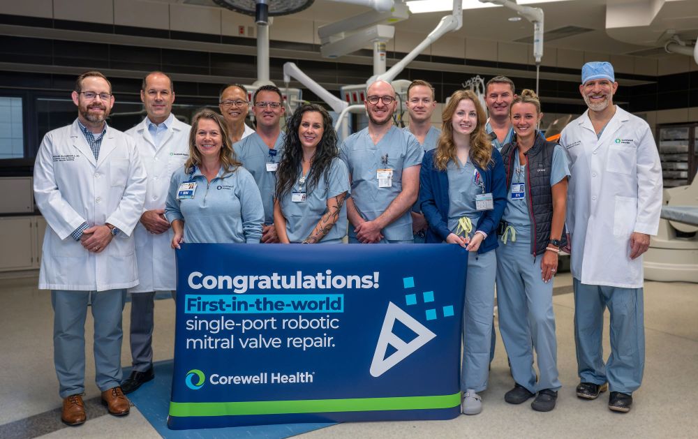 Nurses and doctors in front of banner celebrating robotic surgery success